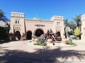 A bar filled with lots of wine bottles and glasses.