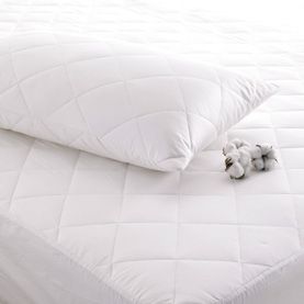 Two white pillows are sitting on top of a white mattress.