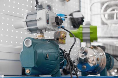 Water pumps on display at a hardware store, various sizes and colors.