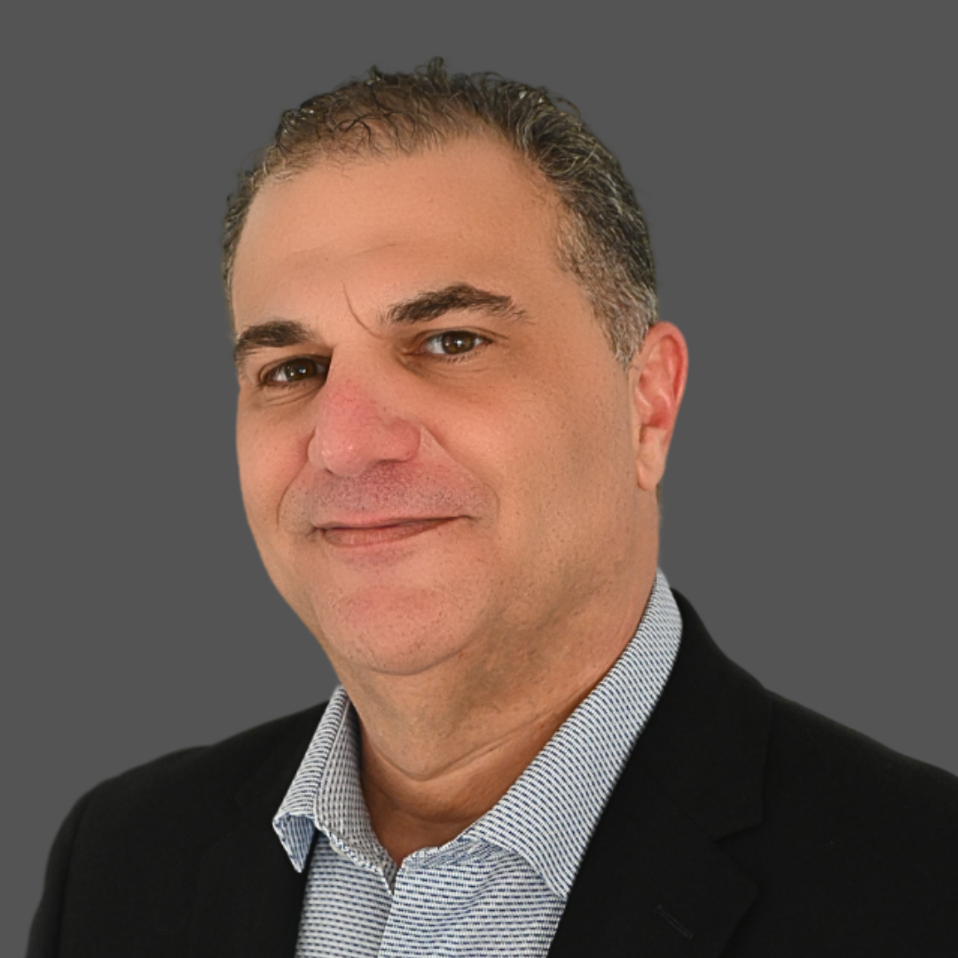 A man in a blue suit is giving a speech in front of a crowd.