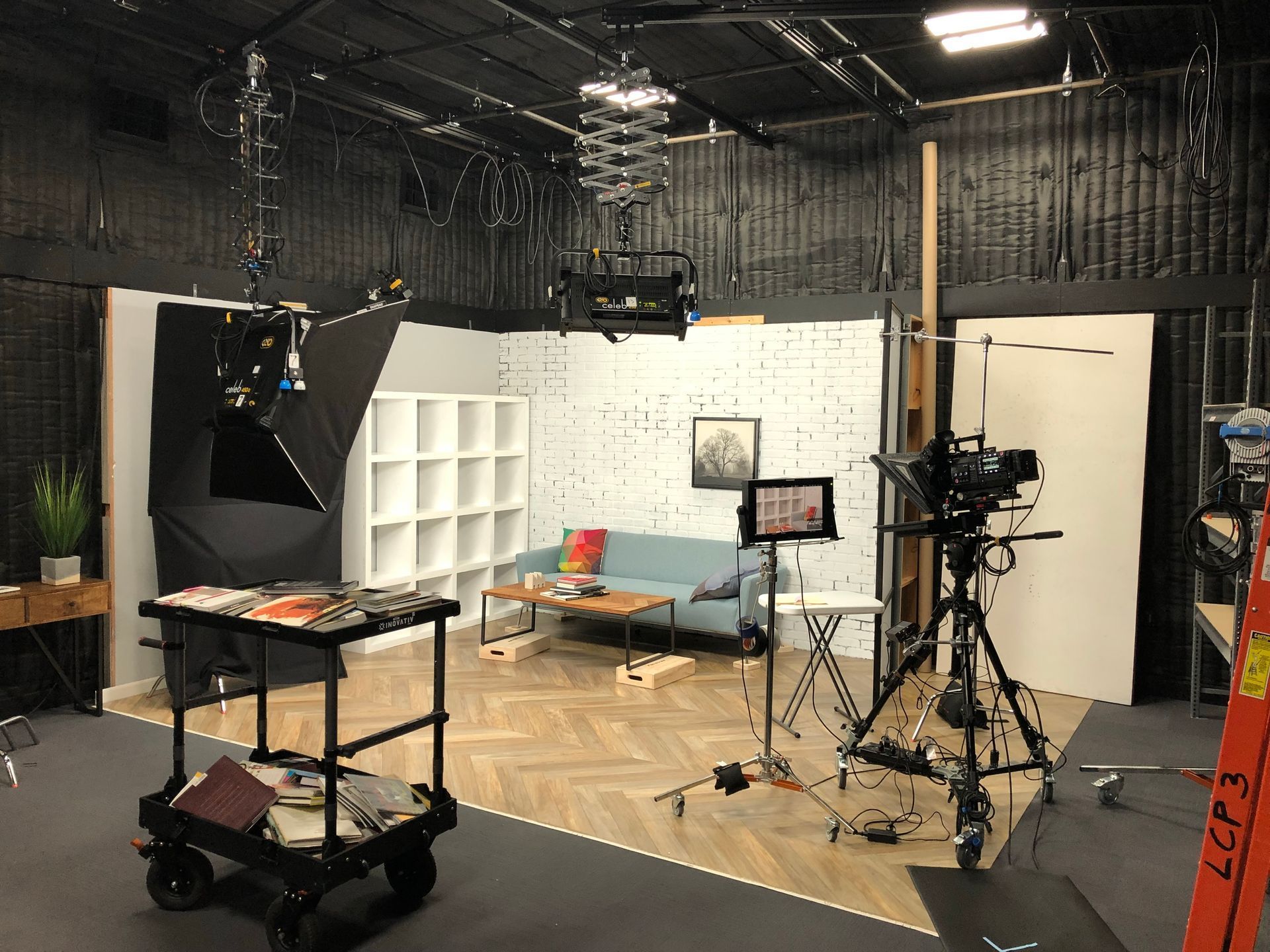 A room with a couch and a camera in it