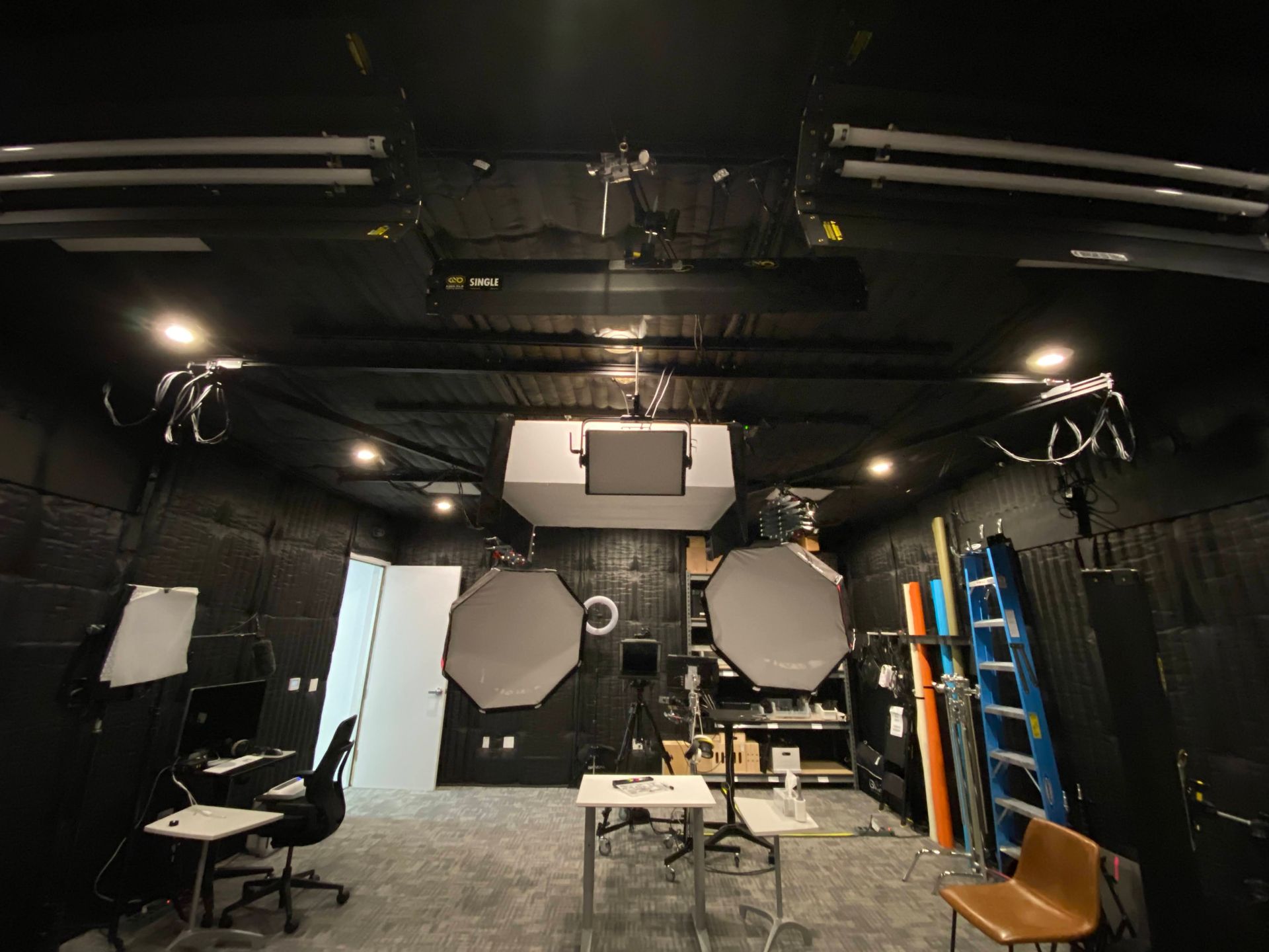 A dark room with a lot of lights on the ceiling