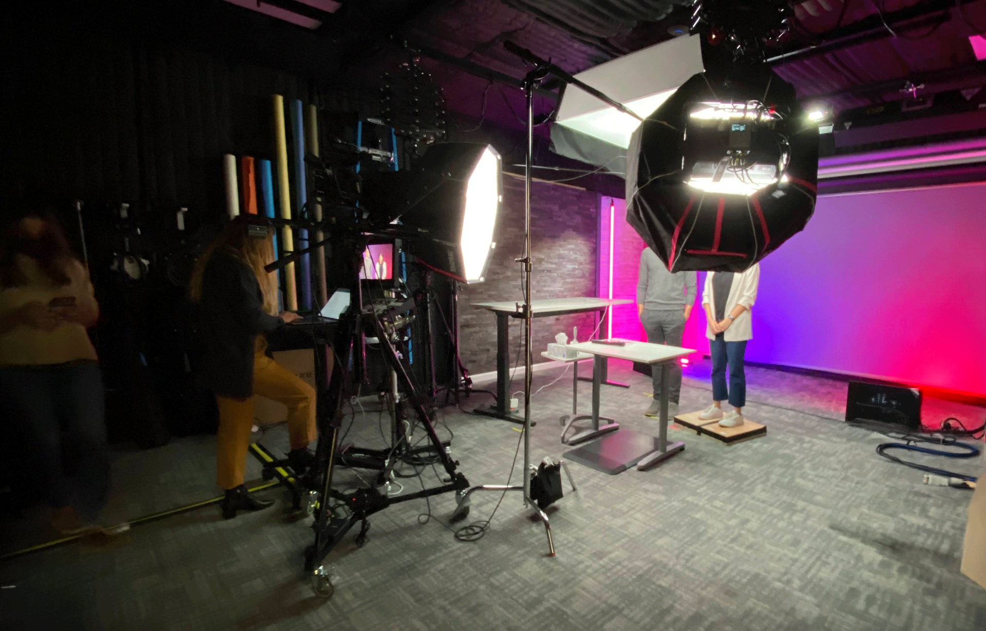 A camera is sitting on a tripod in a dark room.