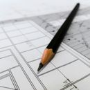 A pencil with an outline of an architectural drawing