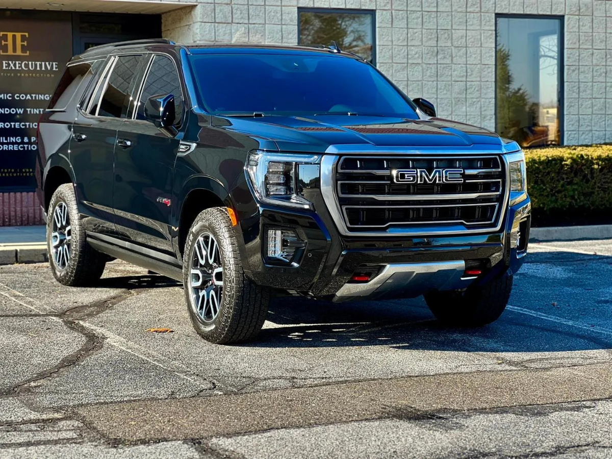 Black GMC Yukon AT4 with all-terrain tires parked outside Executive Auto Protective coating shop