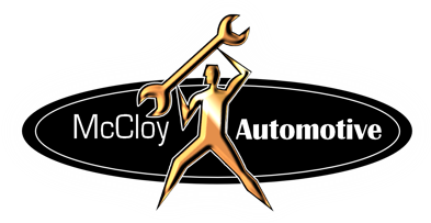 McCloy Automotive logo: Gold figure holding wrench over head within black oval.