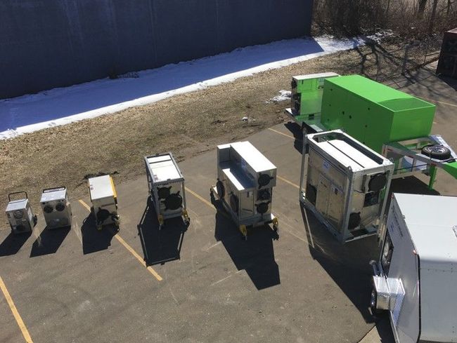 A bunch of trailers are parked in a parking lot