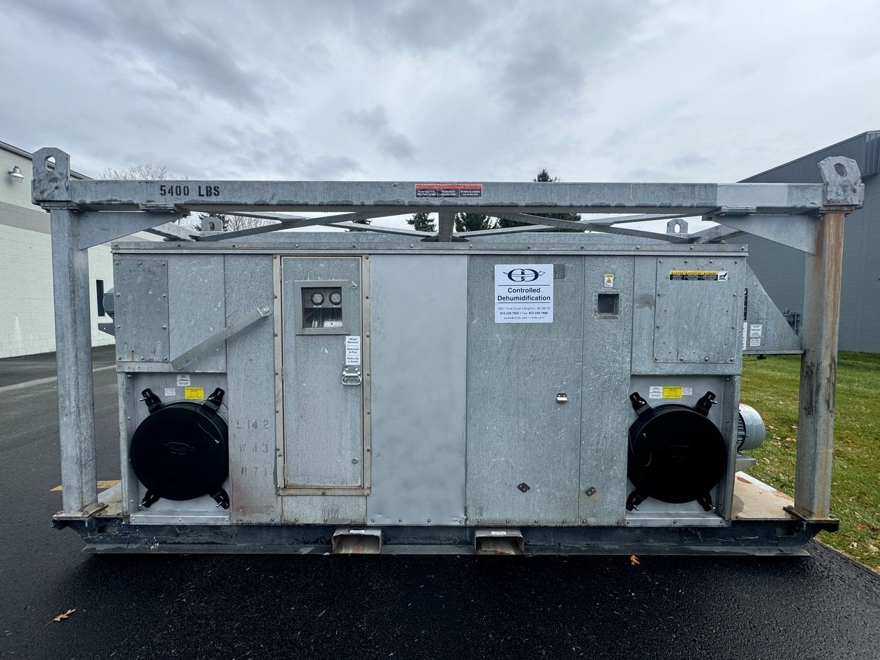 A large metal box is sitting on the side of the road.