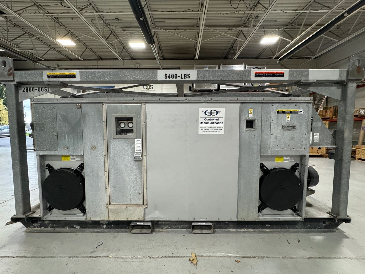 A large metal box is sitting in a warehouse.