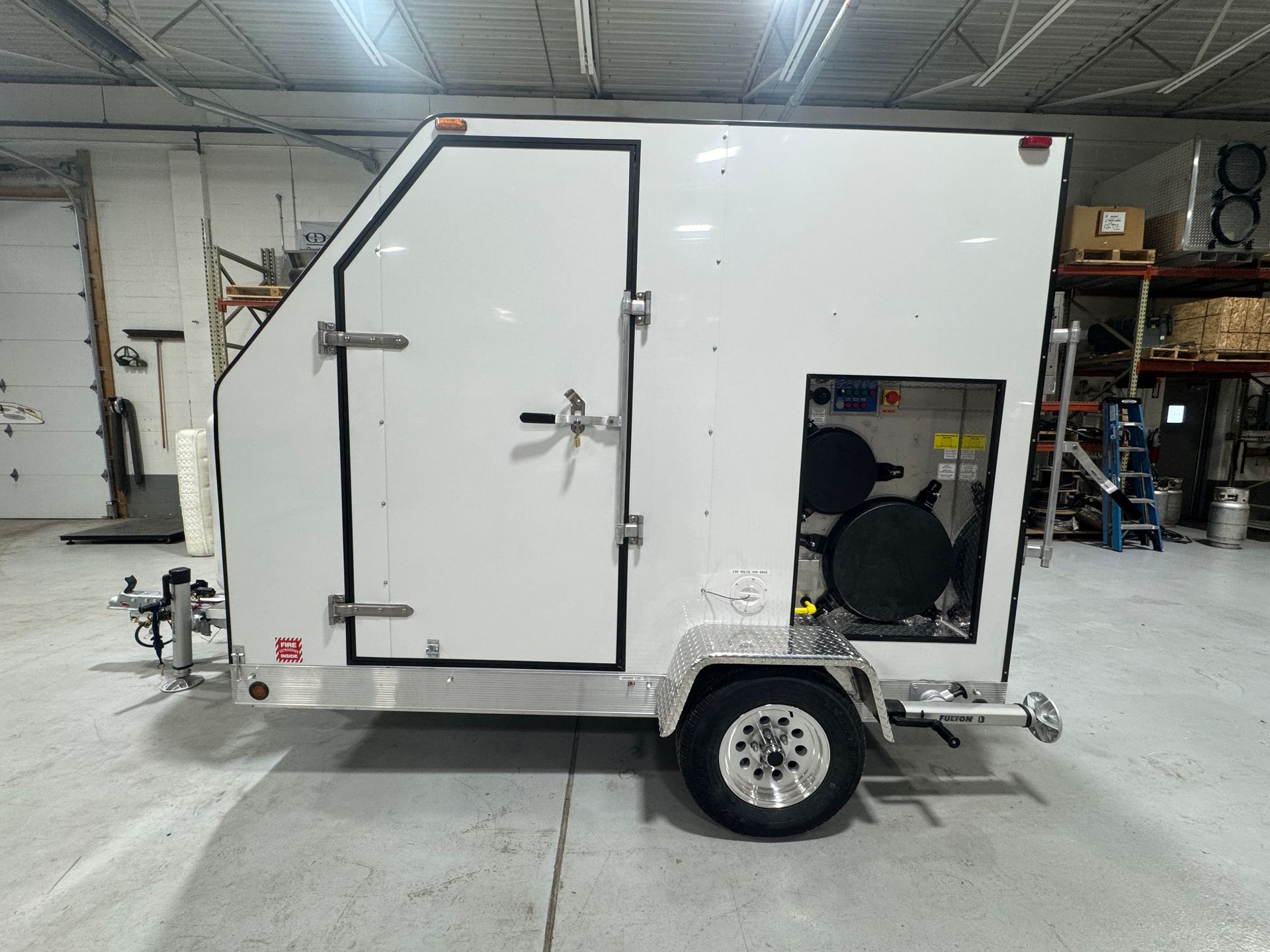 A large metal box is sitting in a warehouse.