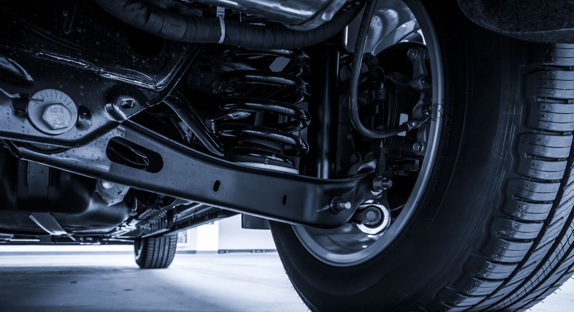 A close up of the underside of a car with a tire.