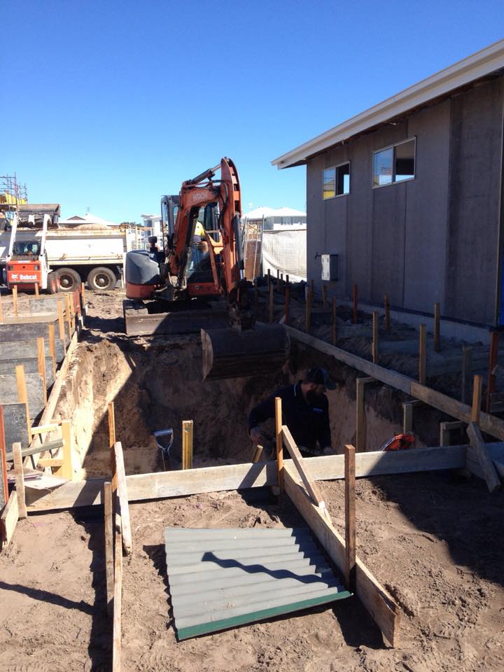 Excavator Digging A Hole — Retaining Wall Builders in Northern Rivers, NSW