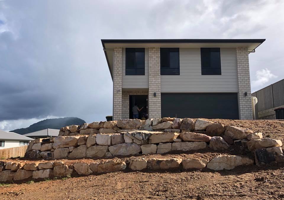Rock Wall Under Construction In Front Of Home — Retaining Wall Builders in Northern Rivers, NSW