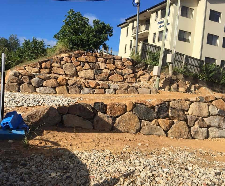Multi Layer Rock Walls Beside A Building  — Retaining Wall Builders in Northern Rivers, NSW