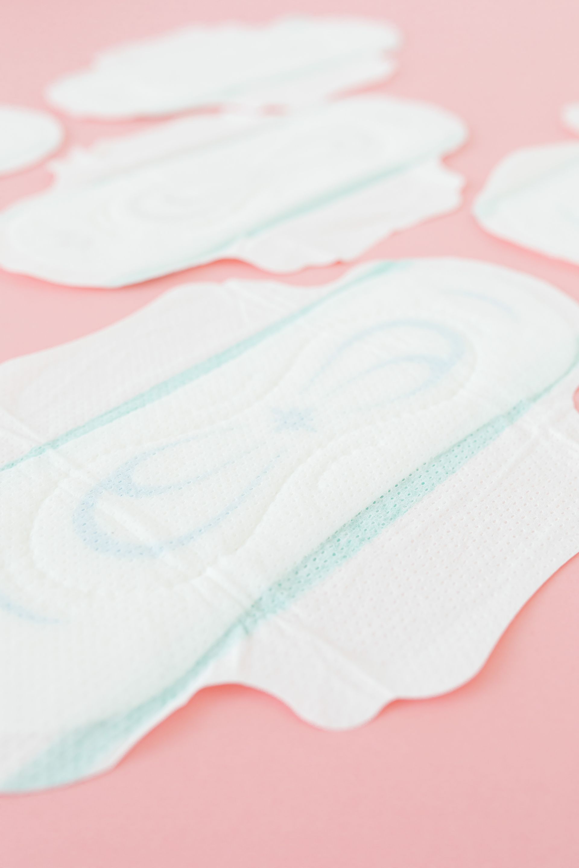 White frost-covered cutout letters on a pink background