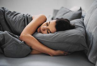 Girl lying down in bed and sleeping