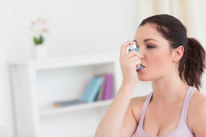 Woman Using Asthma Inhaler — Fort Worth, TX — Dr. James Haden