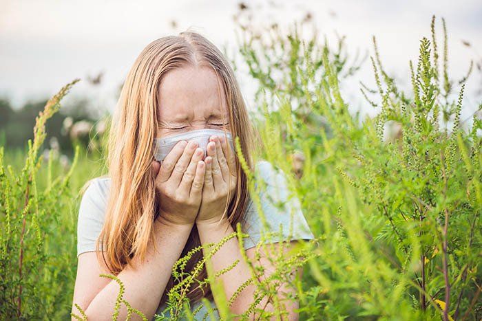 Allergy Testing — Young Woman Sneezes Because of An Allergy to Ragweed in Fort Worth, TX
