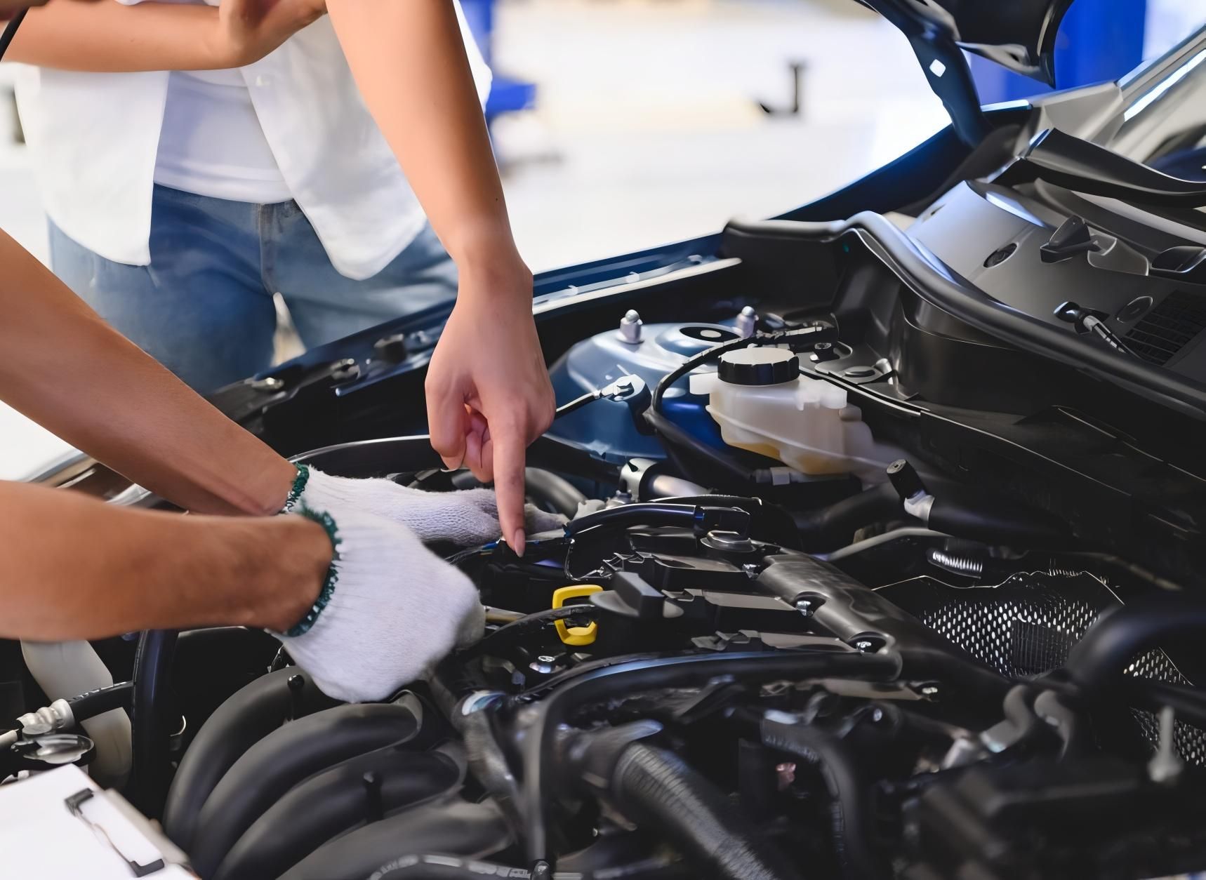 A Man and a Woman Are Working on the Engine of a Car — CWC Auto Services In Campbell, ACT