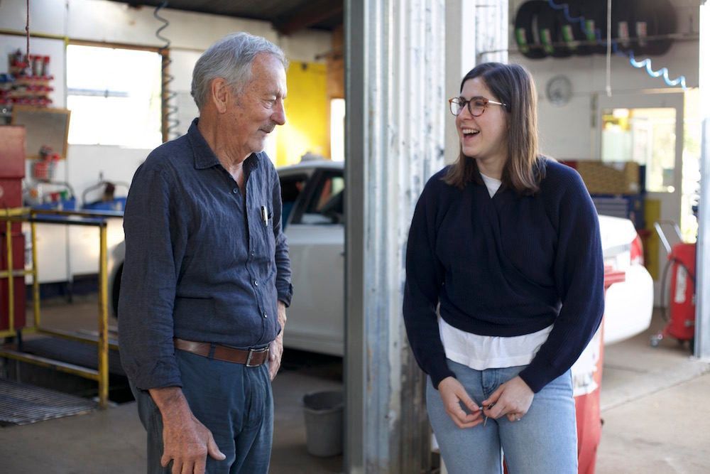 A Man and a Woman Are Standing Next to Each Other in a Garage — CWC Auto Services In Ainslie, ACT