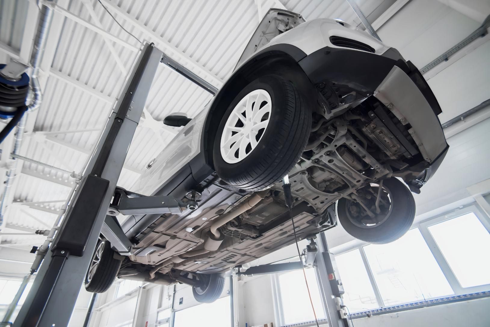 A Car is Sitting on a Lift in a Garage — CWC Auto Services In Ainslie, ACT
