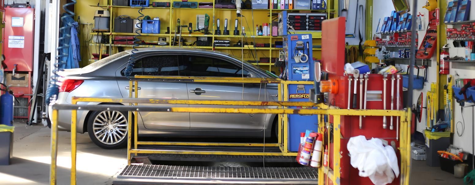 A Car is Sitting on a Lift in a Garage — CWC Auto Services In Ainslie, ACT