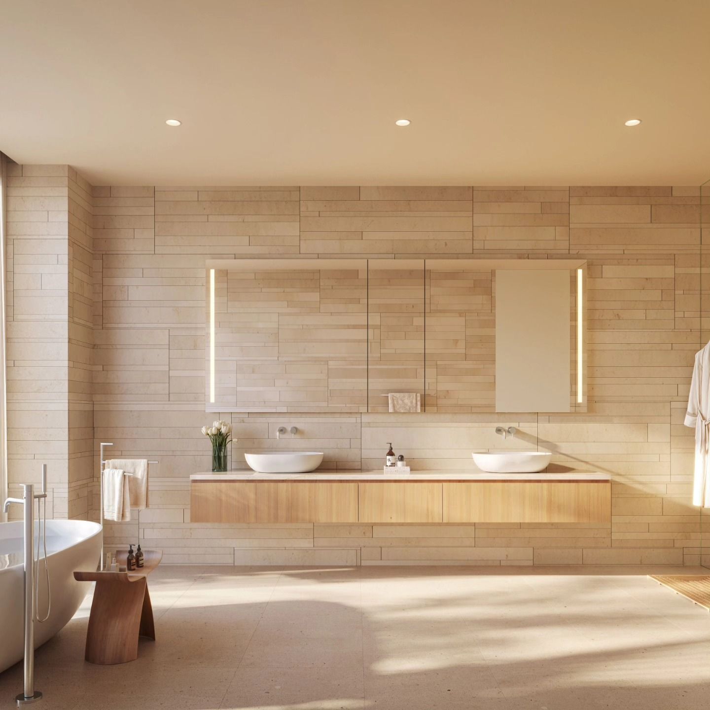Modern beige bathroom with twin sinks, large mirror, bathtub, and warm sunlight on tiled walls