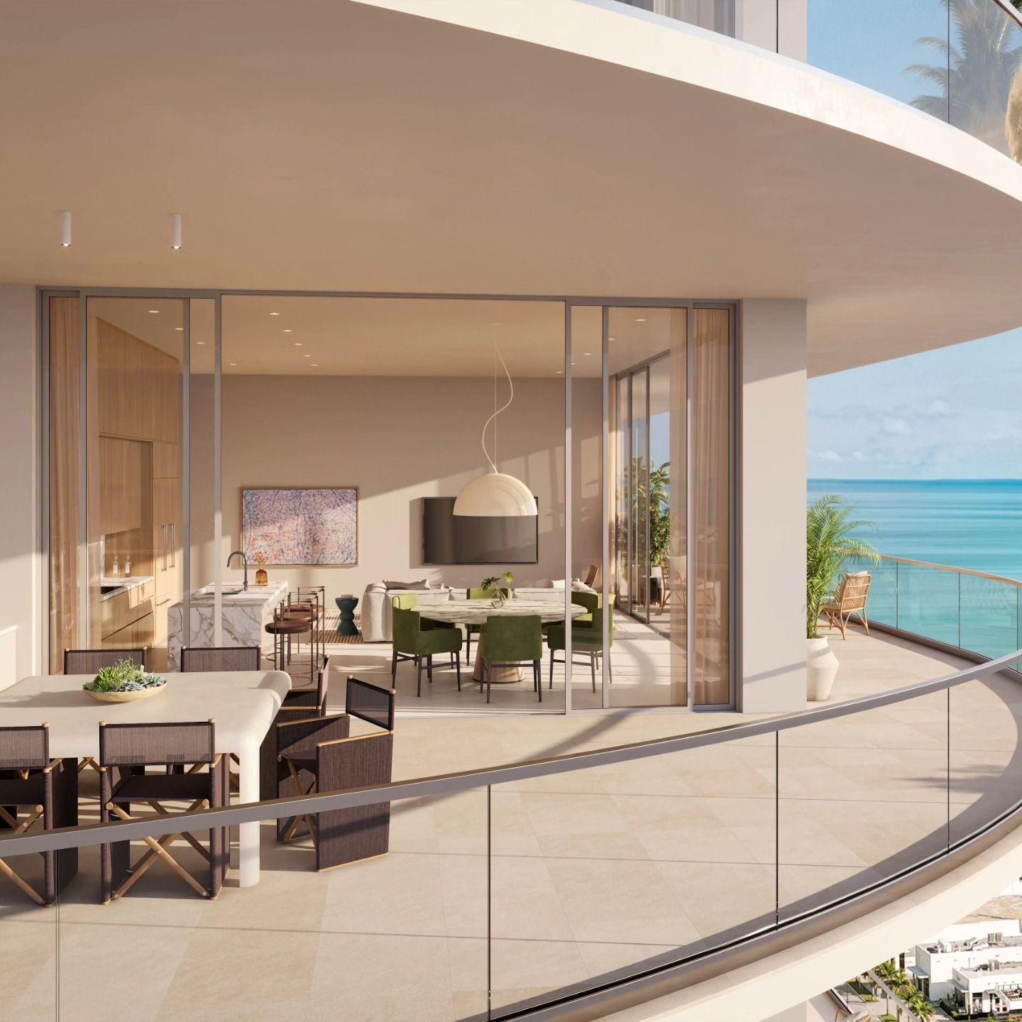 Modern beachfront balcony with dining table and lounge seating overlooking the ocean