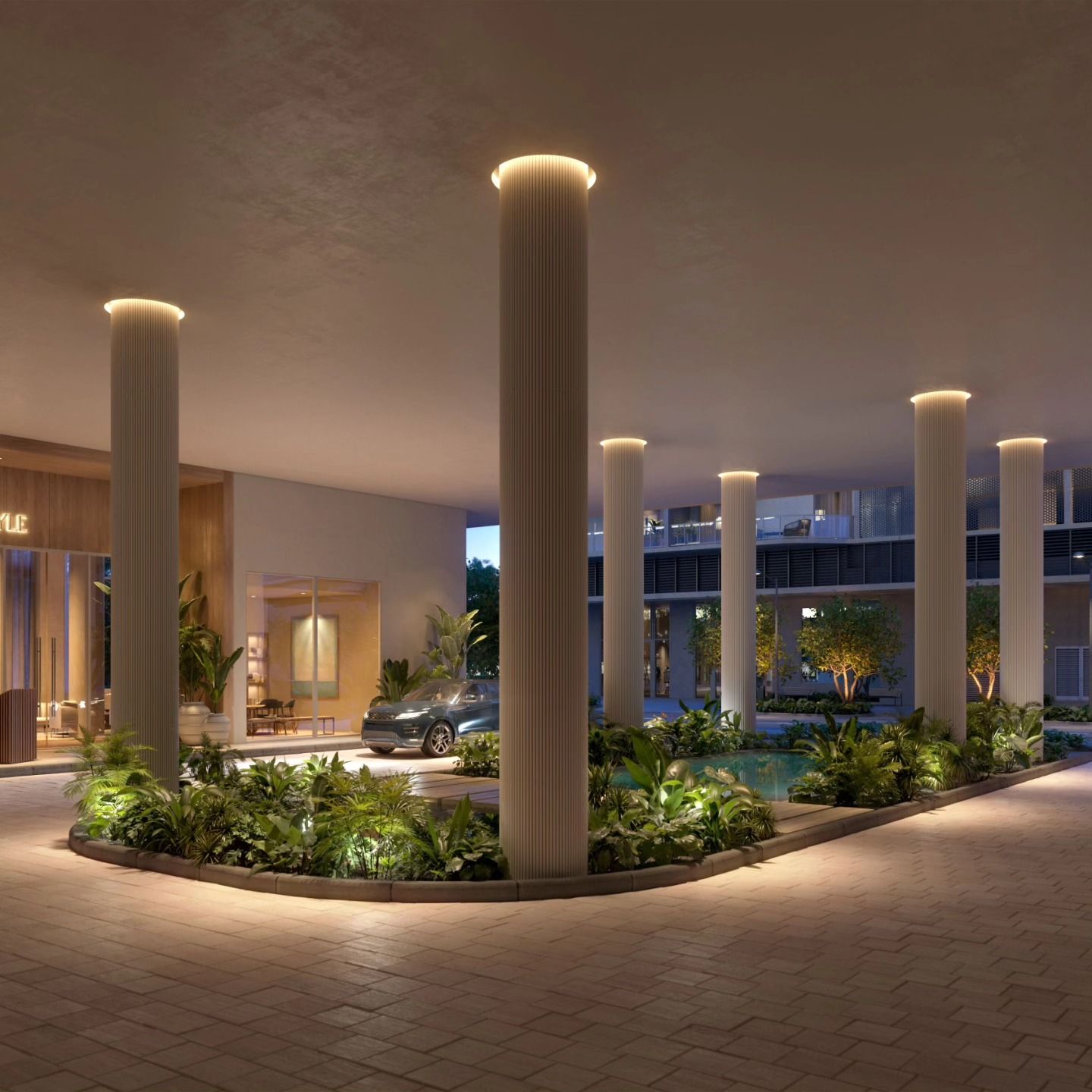 Modern hotel entrance with glowing columns, landscaped planters, and a car arriving at dusk
