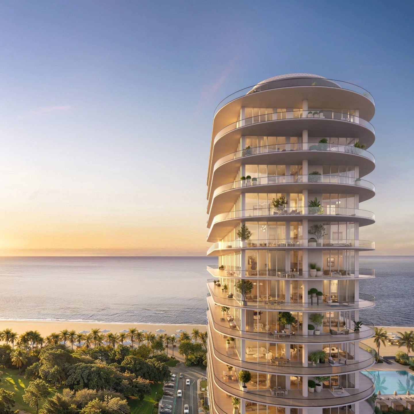 Modern beachfront high-rise with rounded balconies at sunset over the ocean
