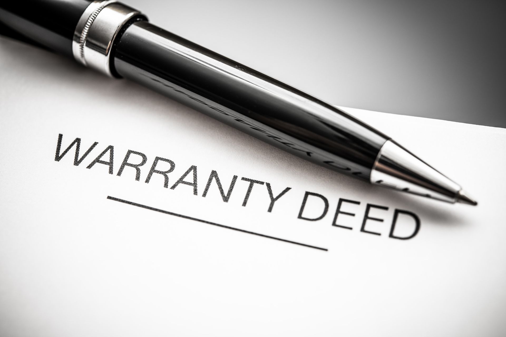 A black pen resting on a paper labeled