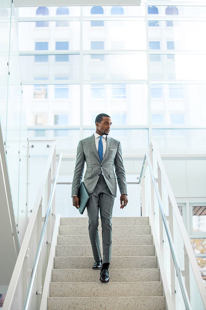 A man in a suit and tie is walking up a set of stairs.