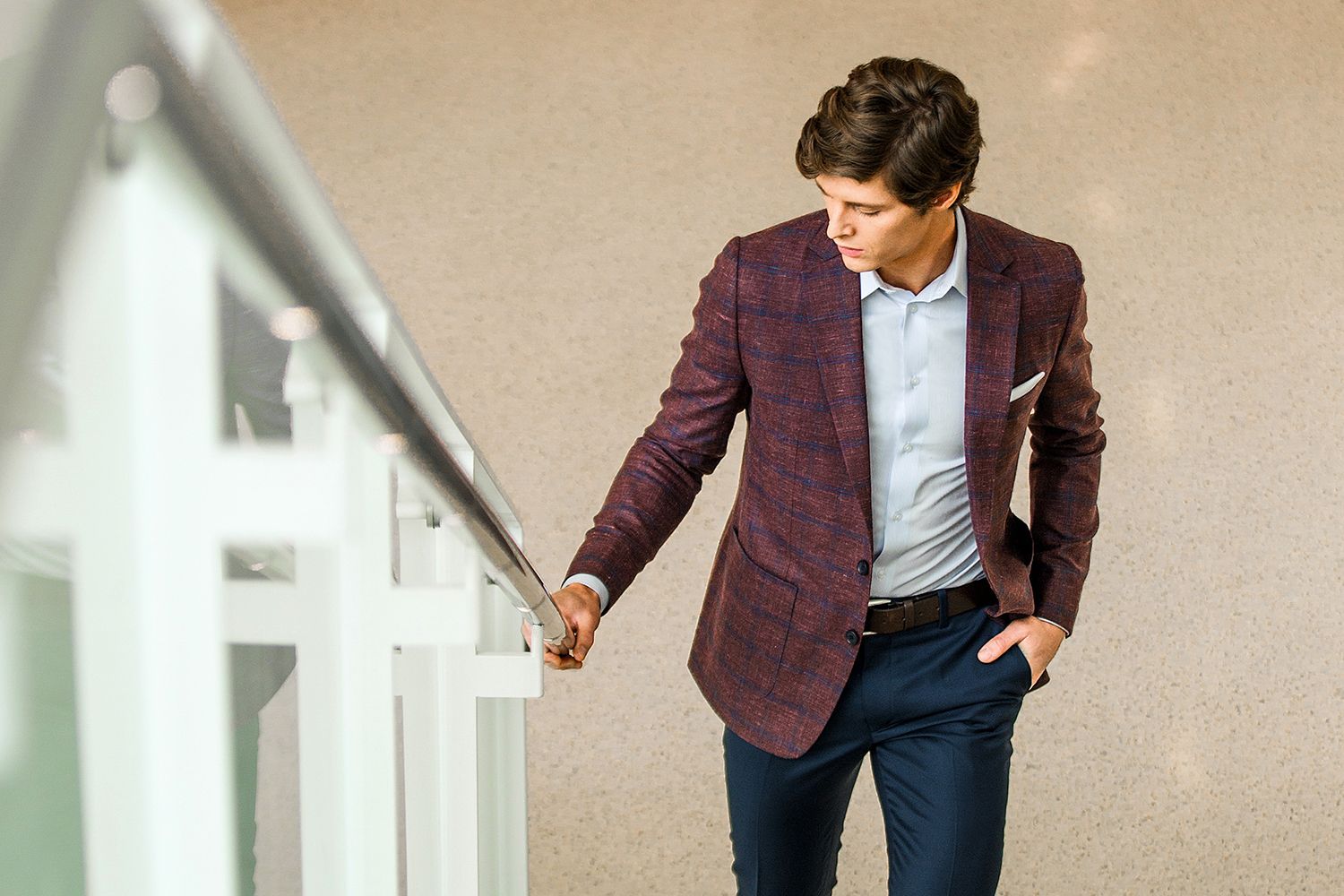 A man in a suit is standing on a set of stairs.