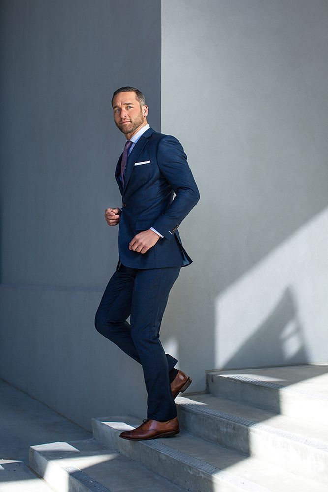 A man in a suit is walking up a set of stairs.