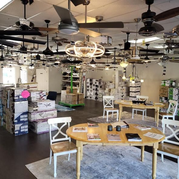 A store filled with tables chairs and ceiling fans