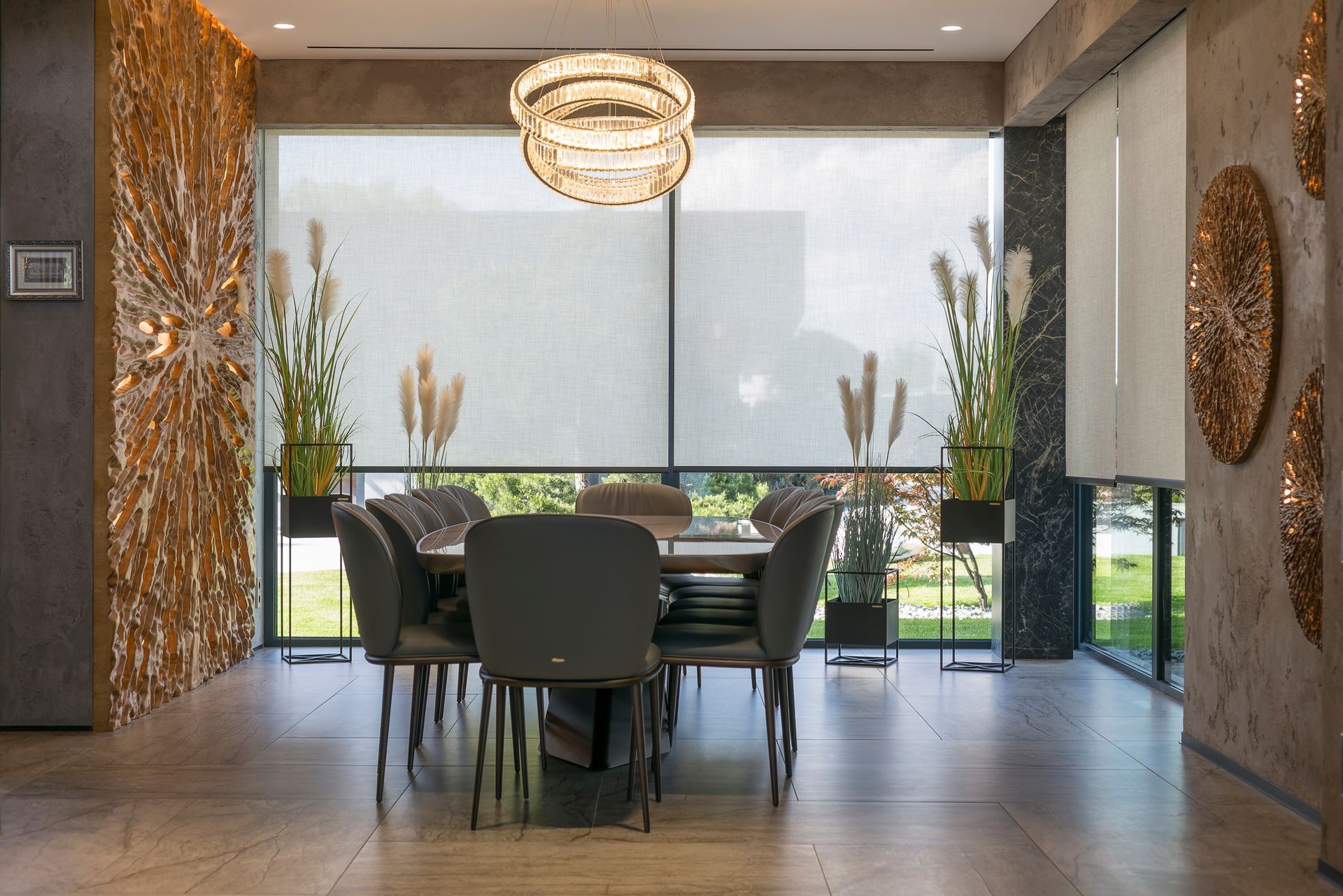 A dining room with a table and chairs and a large window.