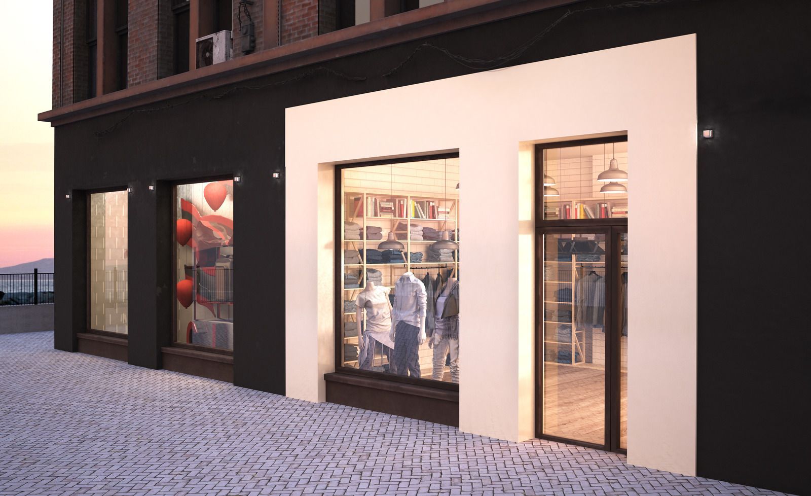 Storefront with display windows; a white frame surrounds the center window and door. Brick walkway, sunset sky.
