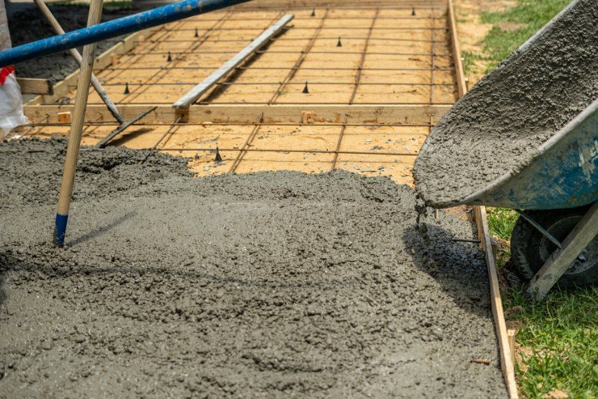 Wheelbarrow Pouring Wet Concrete Into a Wooden-framed Form — Comet Concreting in Drayton, QLD