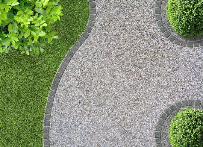 Stone Path Curves Through Grass and Around Trimmed Green Shrubs — Comet Concreting in Drayton, QLD