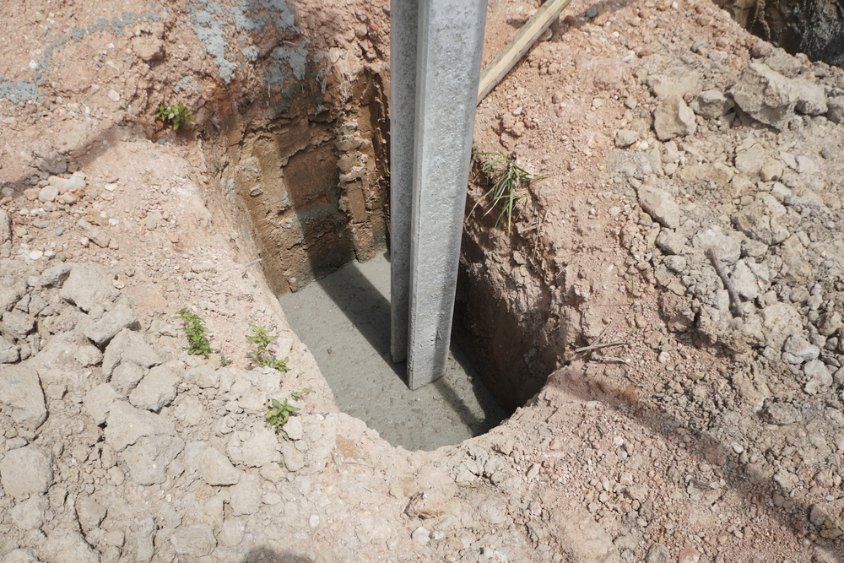 Metal Post Set in Concrete in a Dirt Hole — Comet Concreting in Drayton, QLD
