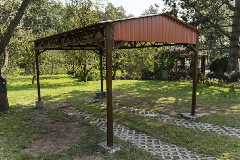 Brown Metal Carport in a Grassy Yard — Comet Concreting in Drayton, QLD