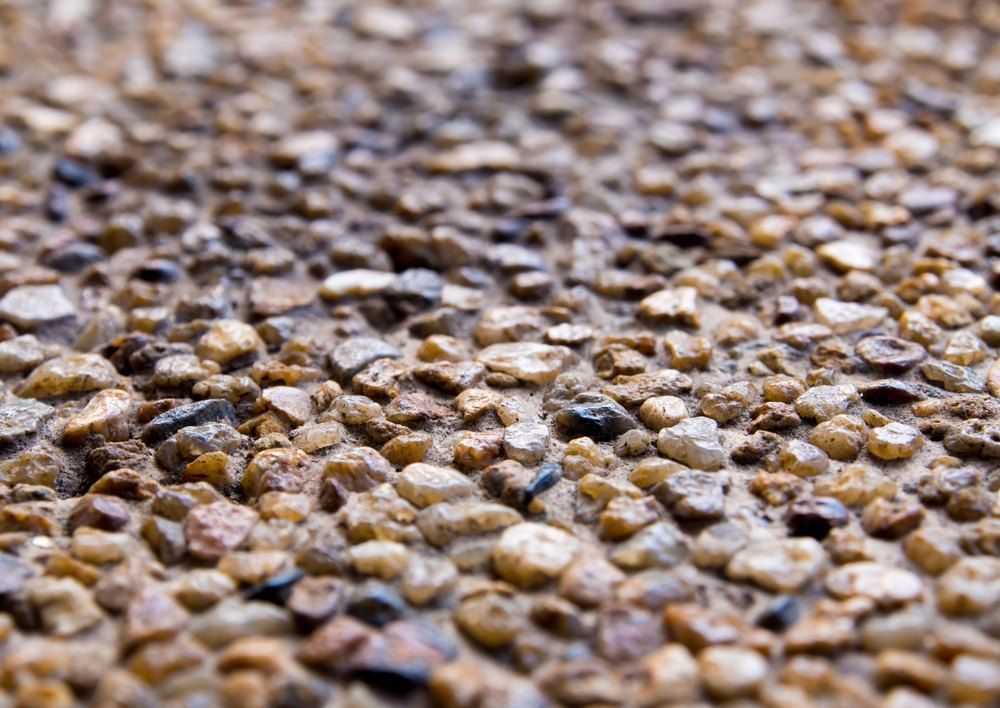 Close-up of Small, Multicolored Pebbles Embedded in Concrete — Comet Concreting in Drayton, QLD