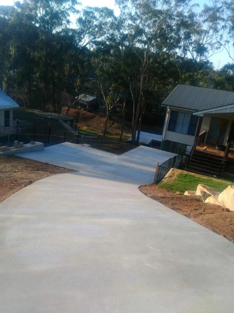 Wide, Paved Driveway Leading Up to Houses — Comet Concreting in Drayton, QLD