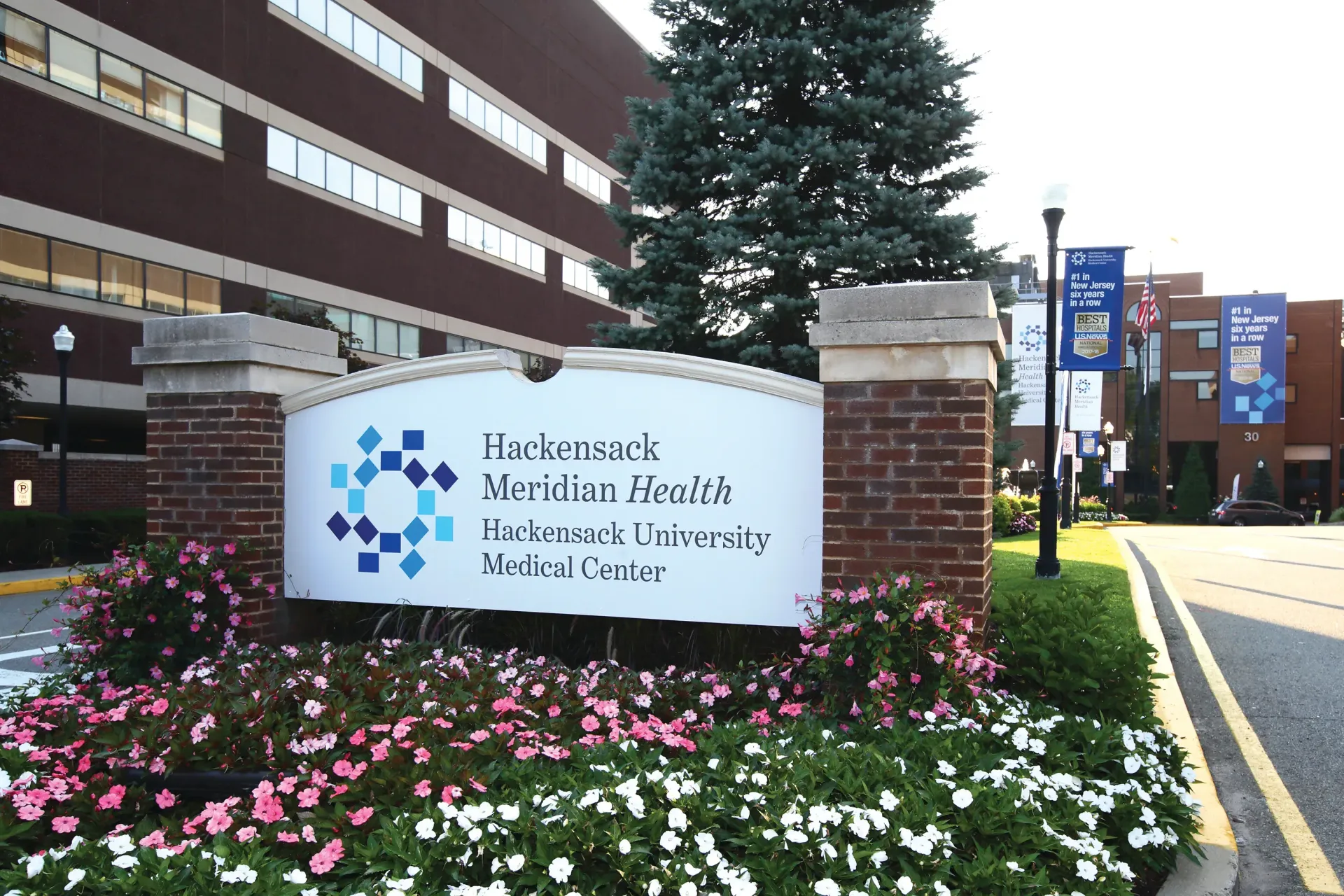 Sign for Hackensack Meridian Health Hackensack University Medical Center; brick and white.