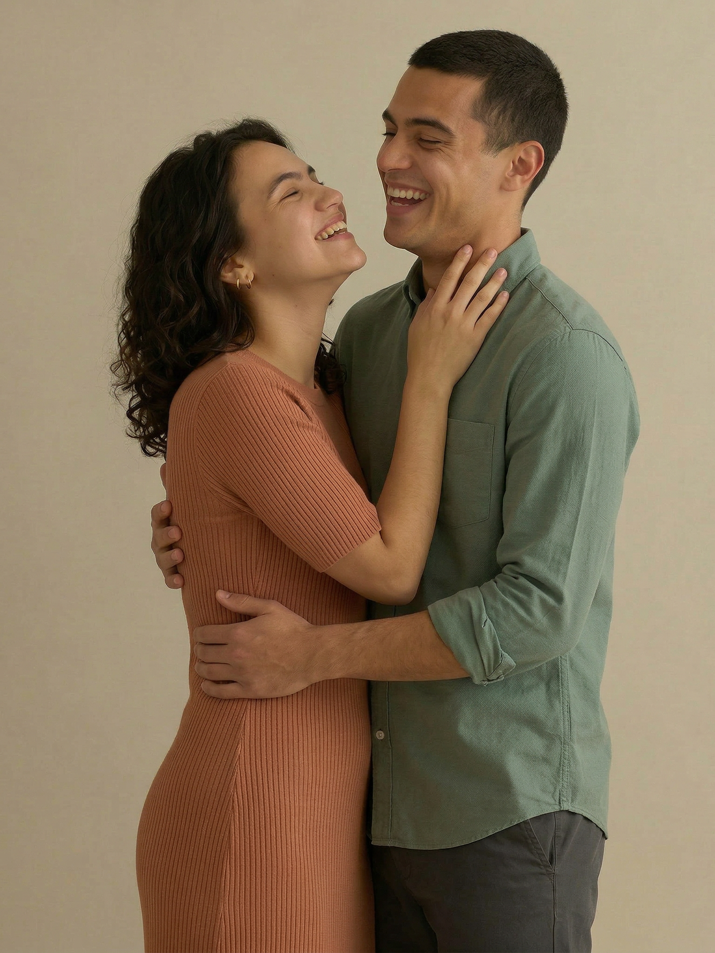 Man with curly hair and a beard, wearing a gray turtleneck, looking at the viewer.