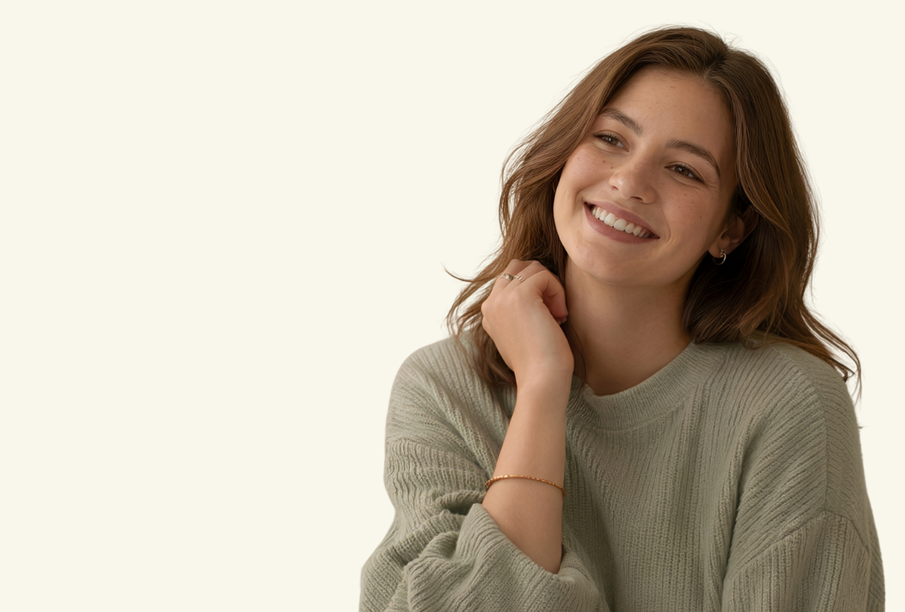 Woman in brown turtleneck, arms crossed, looking down, set against a neutral background.