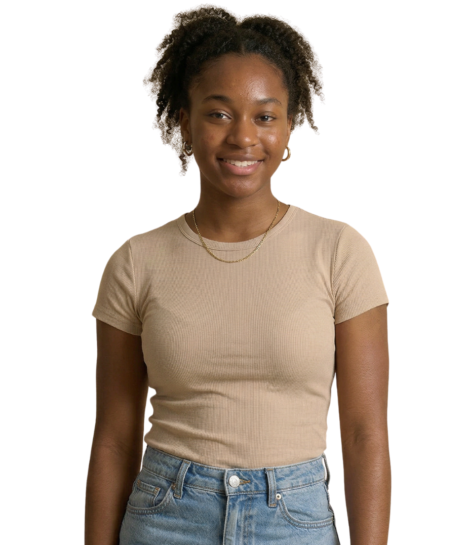 Woman with curly hair, arms crossed, wearing beige top, white pants, standing against white background.