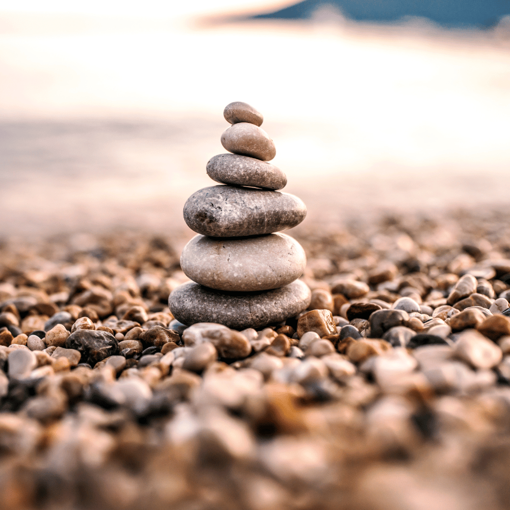 A pile of rocks stacked on top of each other on a beach.