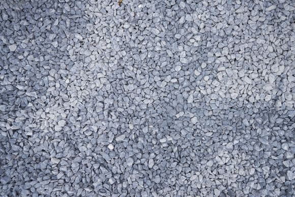 A pile of gravel is sitting on the ground.