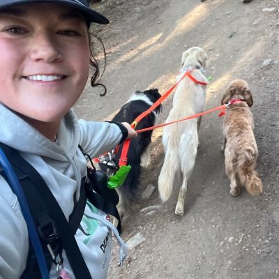 Allie taking a selfie with a group of dogs